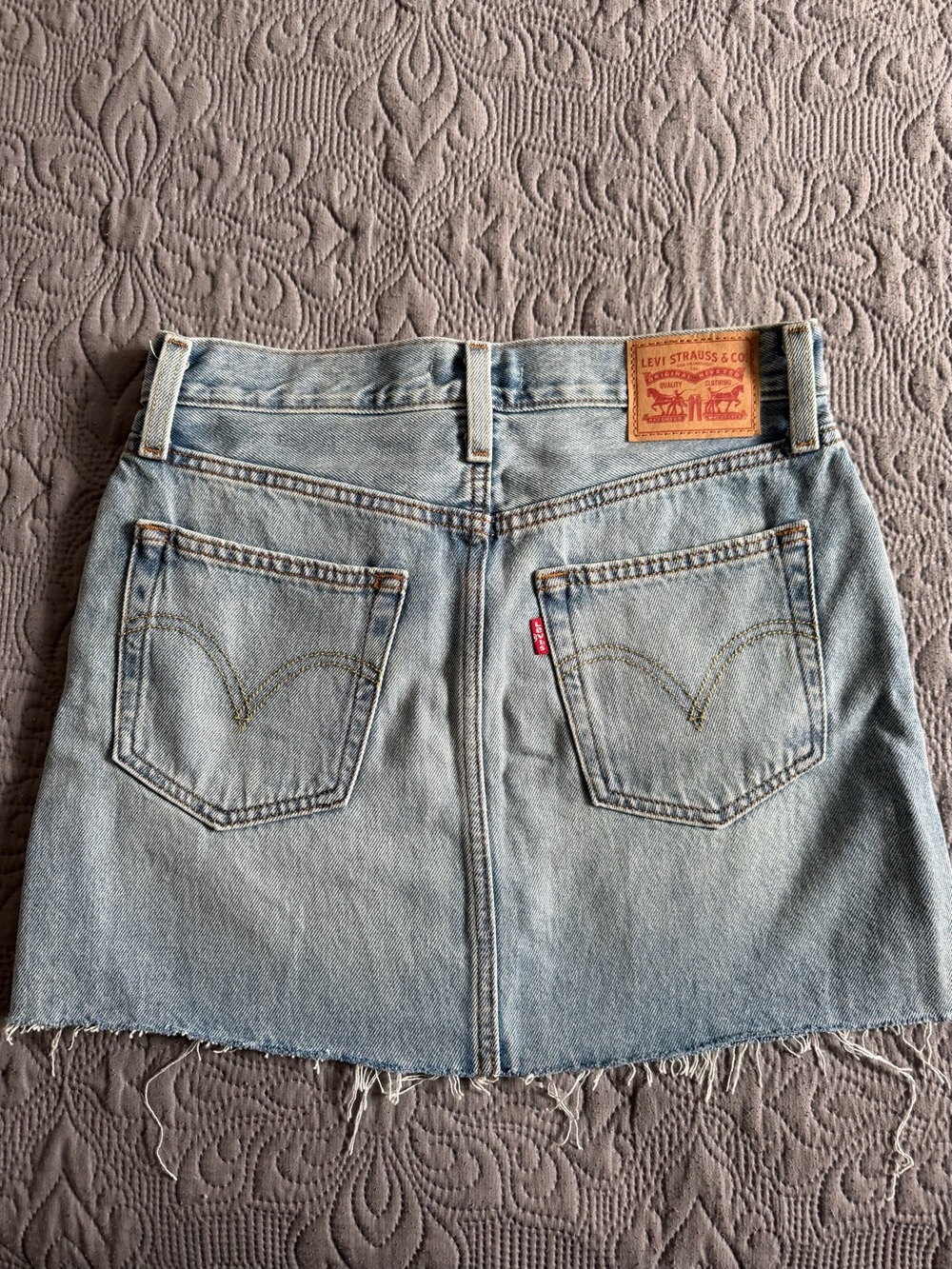 Levi's faded blue denim mini skirt with raw hem
